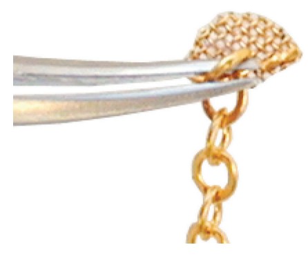 Figure 2D: Bendable feature shows that the Gold Mesh Disk (once cut to ideal shape) is easily bent with any plier to conform to any surface. This provides perfect adaptation for bonding